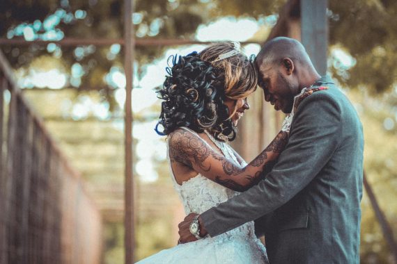 A joyful couple embracing on their wedding day, showcasing love and commitment.